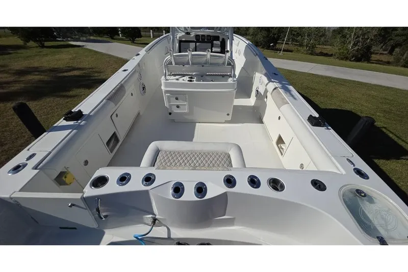 Slide: The Image of 2013 Sailfish 320 CC boat interior with spacious seating and fishing rod holders. - 69