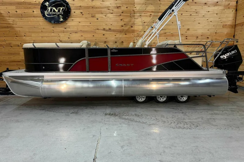 Slide: The Image of 2024 Crest Classic LX 220 SLSC pontoon boat with Suzuki engine in showroom. - 1