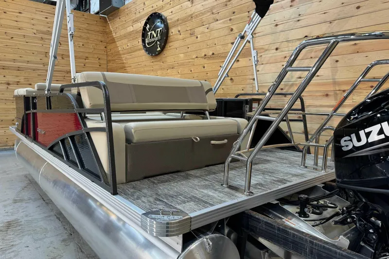 Slide: The Image of 2024 Crest Classic LX 220 SLSC pontoon boat with Suzuki engine in showroom. - 2