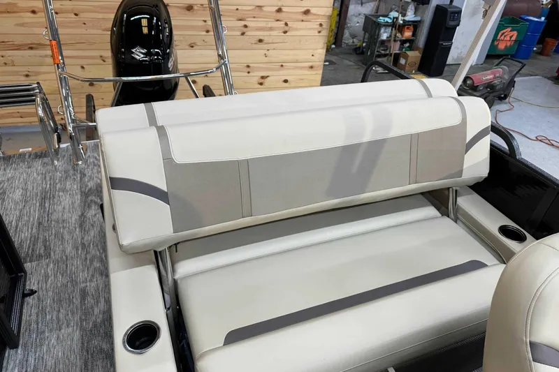 Slide: The Image of 2024 Crest Classic LX 220 SLSC boat interior with beige seating and cup holders. - 7