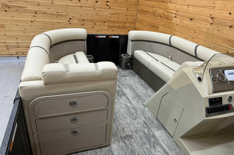 Slide: The Image of 2024 Crest Classic LX 220 SLSC boat interior with beige seating and modern dashboard. - 8