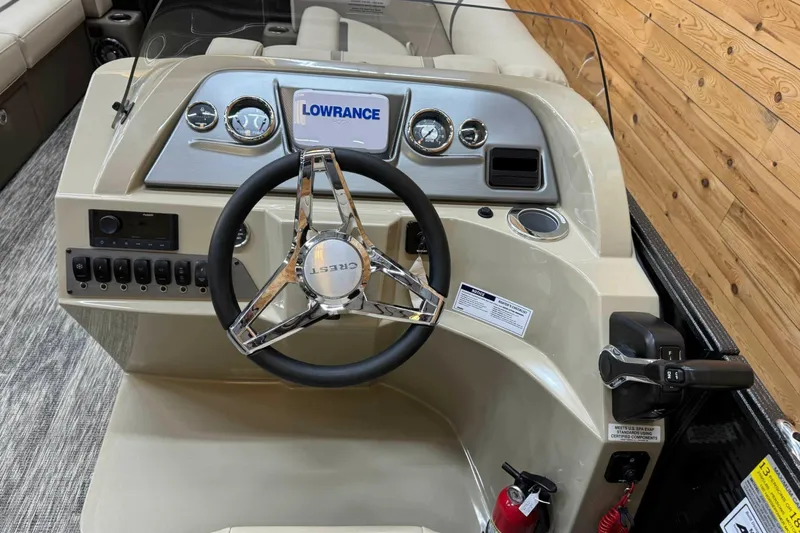 Slide: The Image of 2024 Crest Classic LX 220 SLSC boat dashboard with steering wheel and controls. - 9