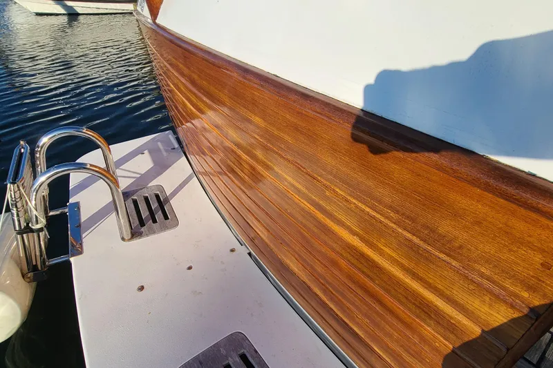 Slide: The Image of Polished wooden deck of 2000 Grand Banks 46 Classic yacht by the water. - 15