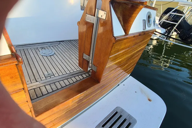 Slide: The Image of Wooden deck and railing of a 2000 Grand Banks 46 Classic yacht by the water. - 16