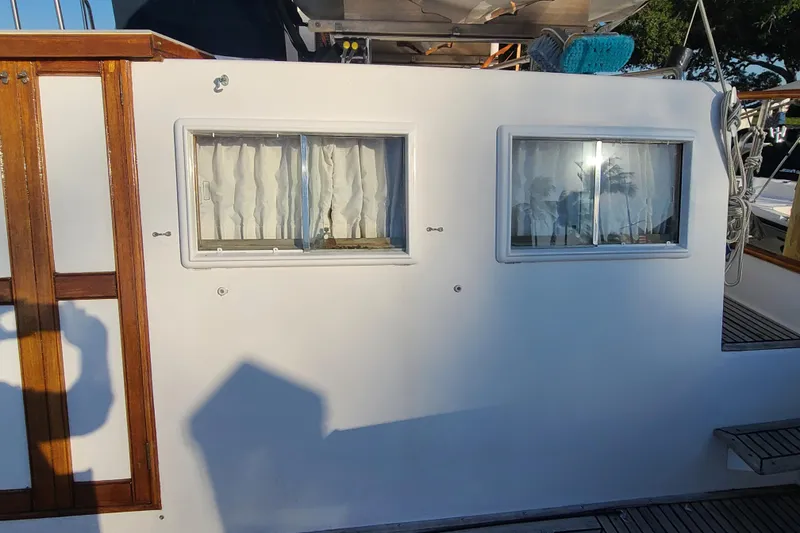 Slide: The Image of Side view of 2000 Grand Banks 46 Classic yacht with windows and wooden trim. - 17