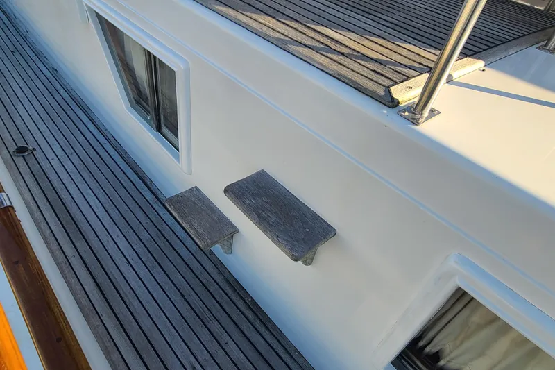 Slide: The Image of Grand Banks 46 Classic 2000 yacht deck with wooden steps and railing. - 18