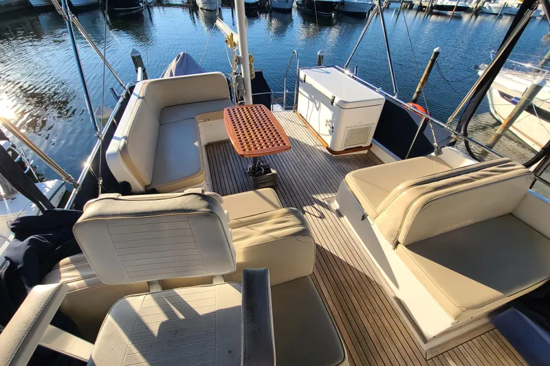 Slide: The Image of Grand Banks 46 Classic 2000 yacht deck with seating and table, docked at marina. - 29