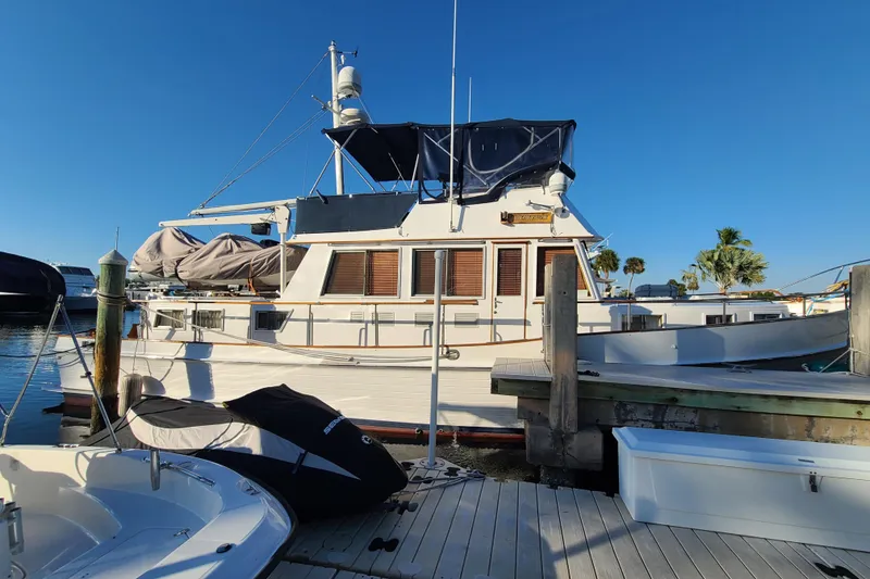 Slide: The Image of Grand Banks 46 Classic yacht docked at marina, 2000 model, under clear blue sky. - 3