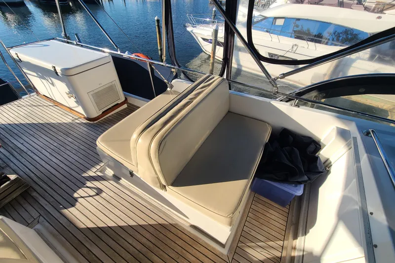 Slide: The Image of Grand Banks 46 Classic 2000 yacht deck with cushioned seating and wooden flooring. - 30