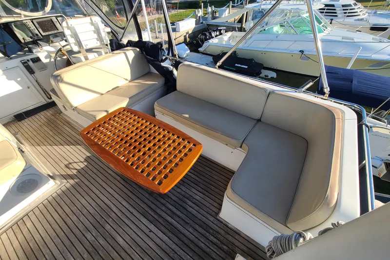 Slide: The Image of Grand Banks 46 Classic 2000 yacht interior with cushioned seating and wooden table. - 32