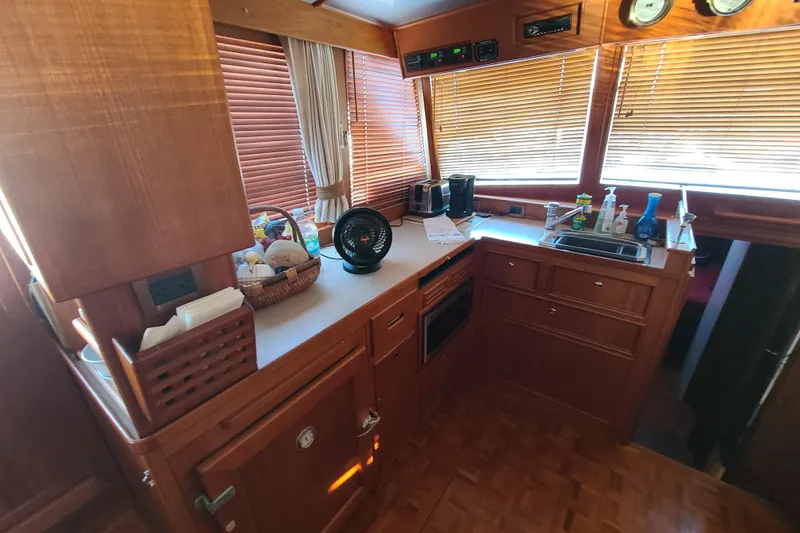 Slide: The Image of Galley kitchen in 2000 Grand Banks 46 Classic yacht with wooden cabinetry and appliances. - 45