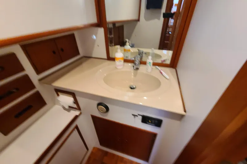 Slide: The Image of Bathroom vanity in 2000 Grand Banks 46 Classic yacht with sink and storage cabinets. - 53