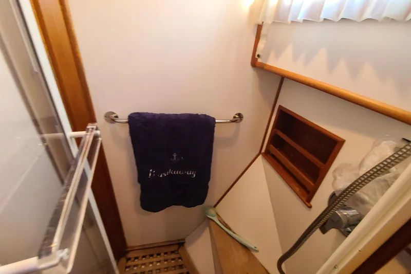 Slide: The Image of Bathroom interior of 2000 Grand Banks 46 Classic yacht with towel and showerhead. - 59