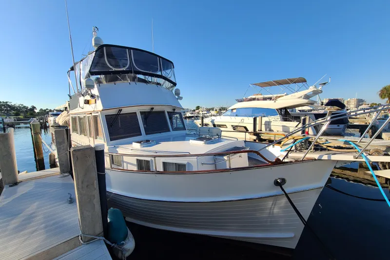 Slide: The Image of Grand Banks 46 Classic yacht docked at marina, 2000 model, clear blue sky. - 6