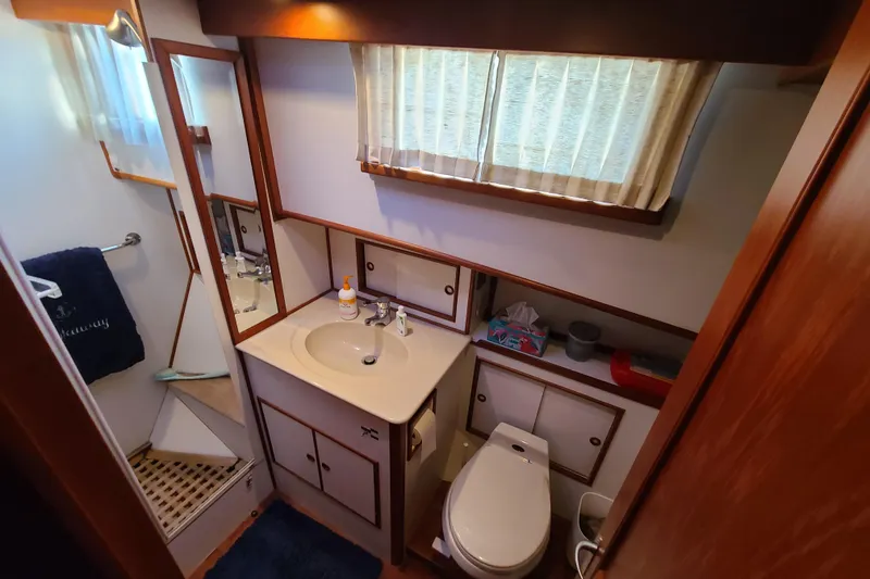 Slide: The Image of Bathroom interior of 2000 Grand Banks 46 Classic yacht, featuring sink, toilet, and shower. - 60
