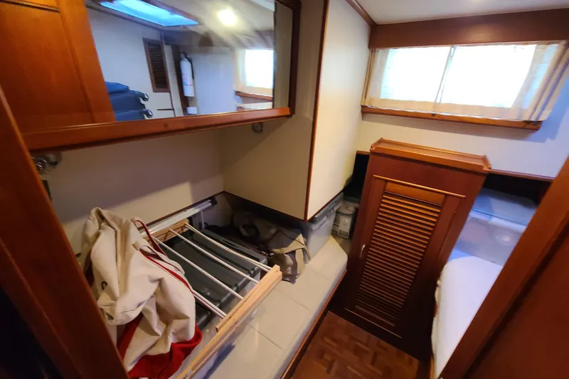 Slide: The Image of Interior cabin of 2000 Grand Banks 46 Classic yacht with wooden finishes and storage. - 63