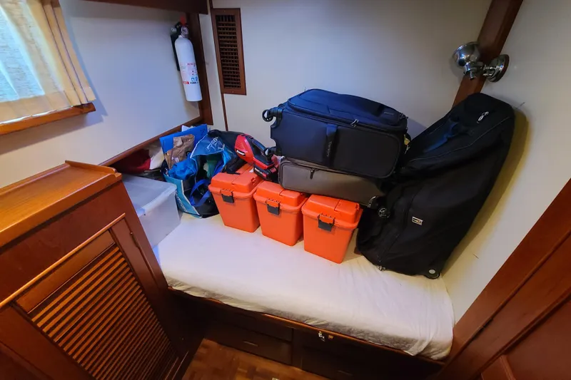 Slide: The Image of Storage area in a 2000 Grand Banks 46 Classic with luggage and equipment. - 64
