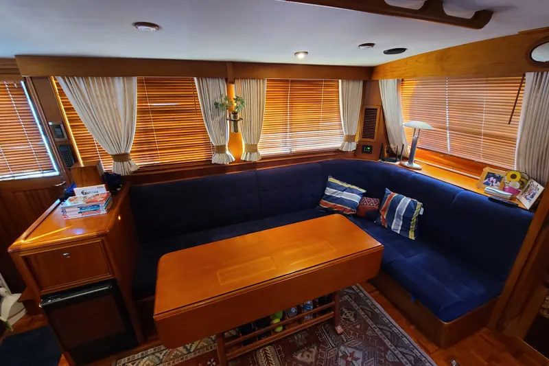 Slide: The Image of Luxurious interior of 2000 Grand Banks 46 Classic yacht with elegant wood finishes and cozy seating. - 72