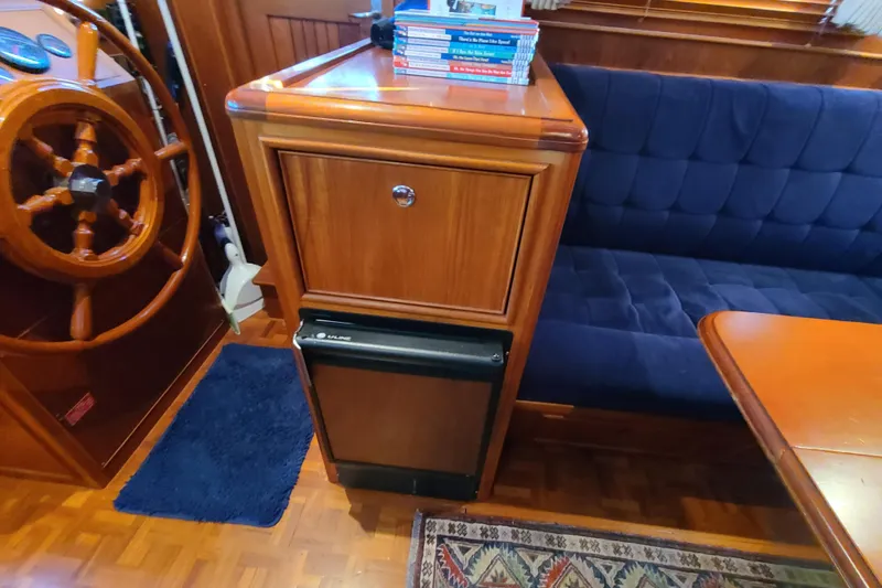 Slide: The Image of Interior of 2000 Grand Banks 46 Classic yacht with wooden helm and blue seating. - 73