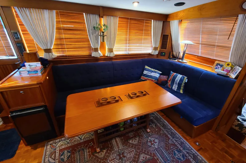 Slide: The Image of Interior of 2000 Grand Banks 46 Classic yacht with cozy seating and wooden table. - 75