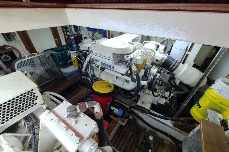 Slide: The Image of Engine room of a 2000 Grand Banks 46 Classic yacht, featuring a Caterpillar engine. - 78