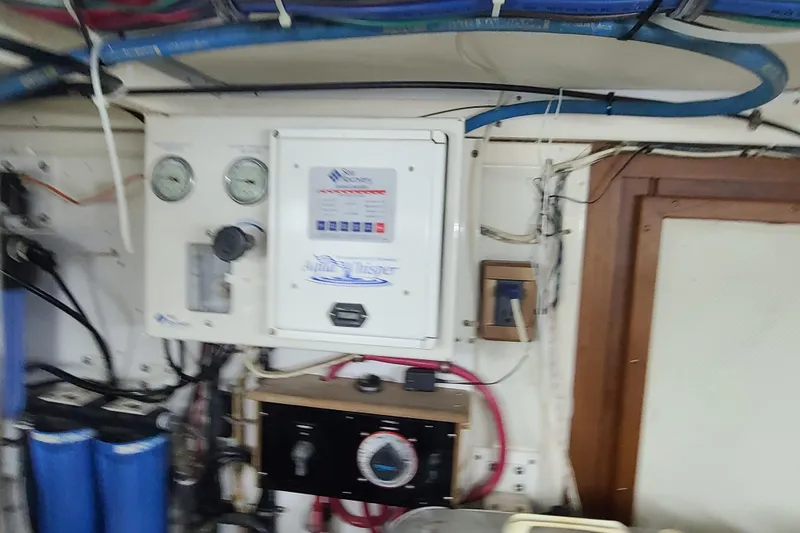 Slide: The Image of Engine room of 2000 Grand Banks 46 Classic with control panel and gauges. - 83