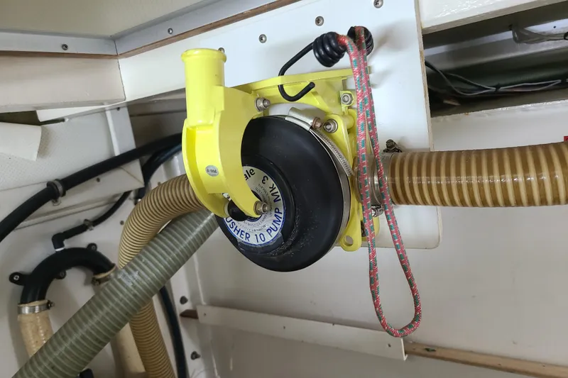 Slide: The Image of Yellow manual bilge pump in a 2000 Grand Banks 46 Classic boat engine room. - 86