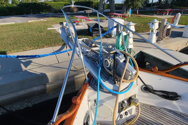 Slide: The Image of Bow of 2000 Grand Banks 46 Classic yacht docked, featuring ropes and equipment. - 9