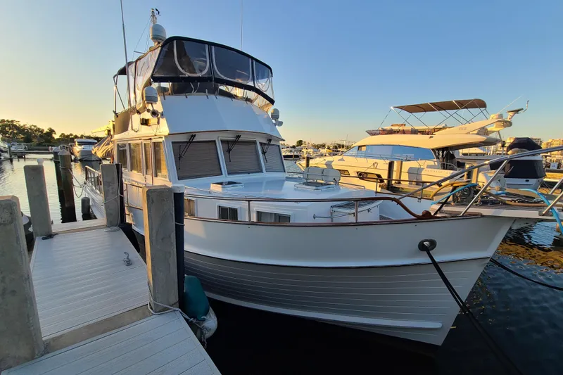 Slide: The Image of 2000 Grand Banks 46 Classic yacht docked at marina during sunset. - 92