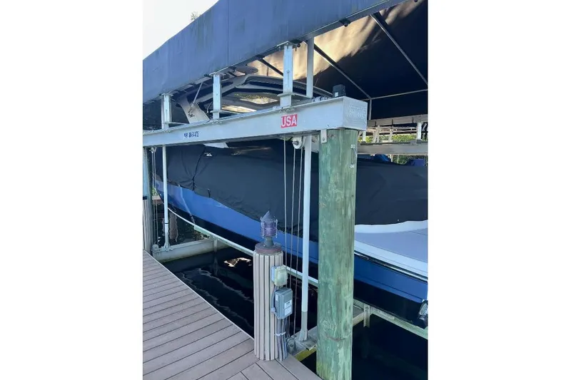 Slide: The Image of 2018 Sae Ray 38SLV OB boat on lift, covered and docked. - 11