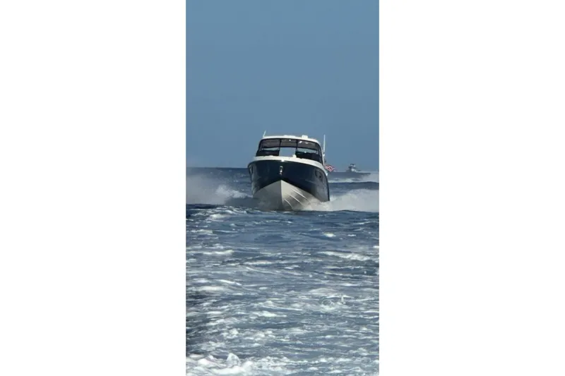 Slide: The Image of 2018 Sae Ray 38SLV OB boat cruising on open water. - 13