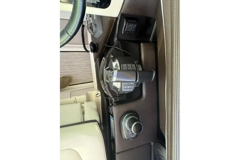 Slide: The Image of 2018 Sea Ray 38SLV OB boat control panel with steering wheel and Joy stick controls throttle. - 21