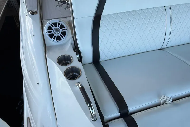 Slide: The Image of Luxurious 2018 Sea Ray 38SLV OB boat interior with white quilted seating and cup holders. - 26