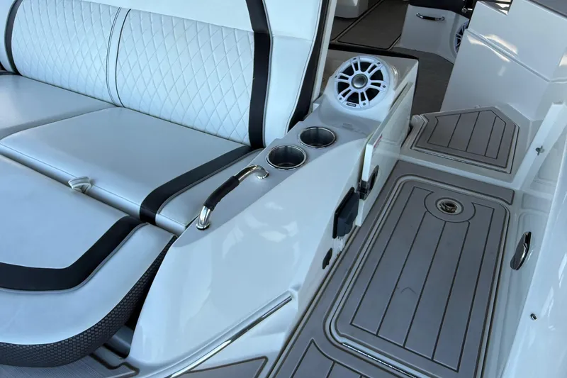 Slide: The Image of 2018 Sea Ray 38SLV OB boat interior with white seating, cup holders, and speaker. - 28