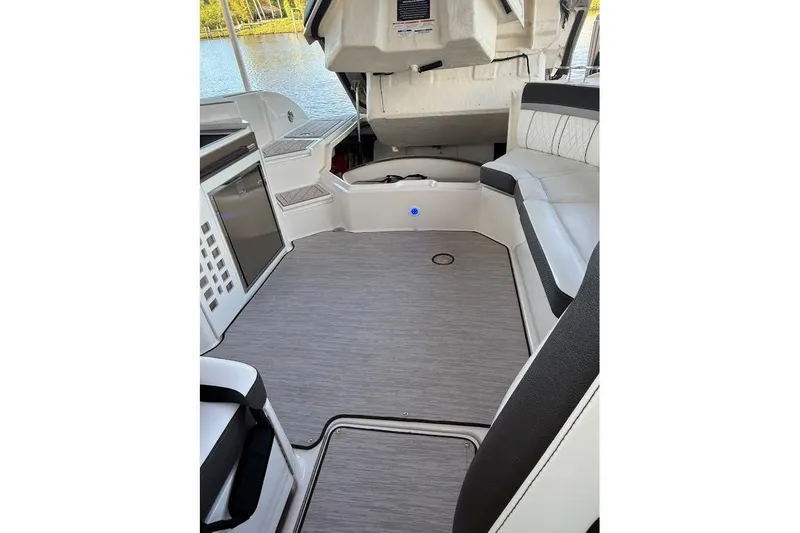 Slide: The Image of 2018 Sea Ray 38SLV OB boat interior with seating and storage, docked by a lake - 35