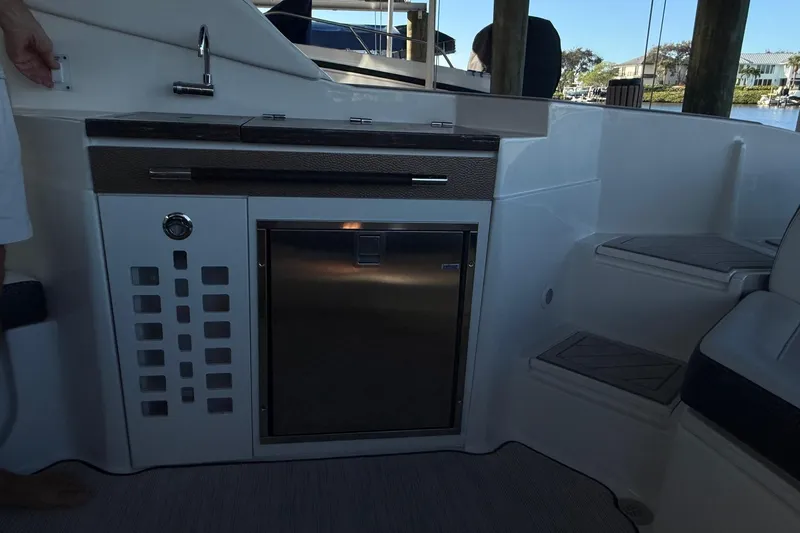 Slide: The Image of 2018 Sea Ray 38SLV OB boat interior with kitchenette and seating area. - 37