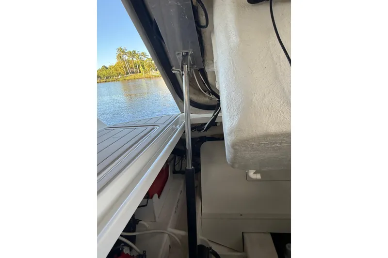 Slide: The Image of 2018 Sae Ray 38SLV OB boat interior with open hatch, lake view, and palm trees. - 39