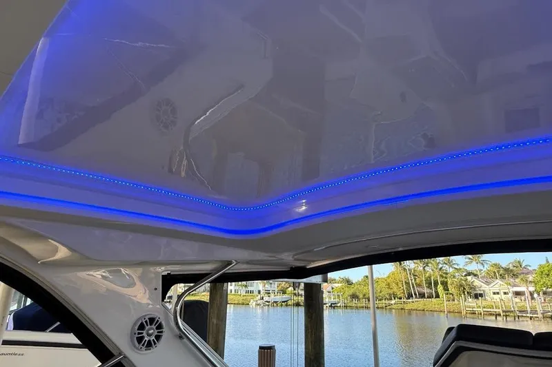 Slide: The Image of 2018 Sae Ray 38SLV OB boat interior with blue LED lighting and waterfront view. - 40