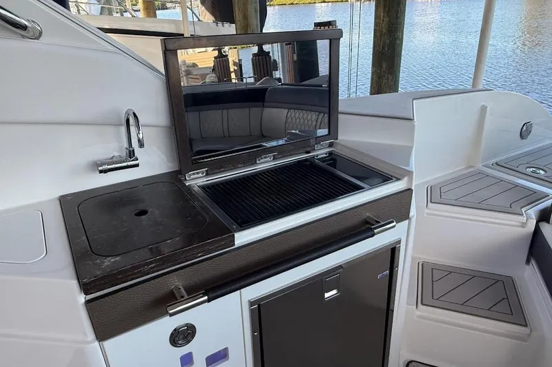 Slide: The Image of Outdoor kitchen on 2018 Sae Ray 38SLV OB yacht with grill and sink by the water. - 46