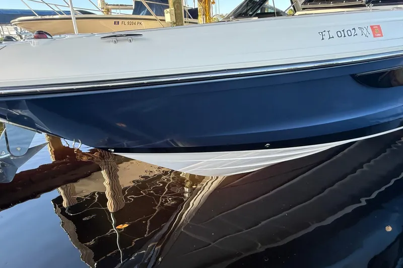 Slide: The Image of 2018 Sae Ray 38SLV OB boat docked, reflecting on calm water. - 5