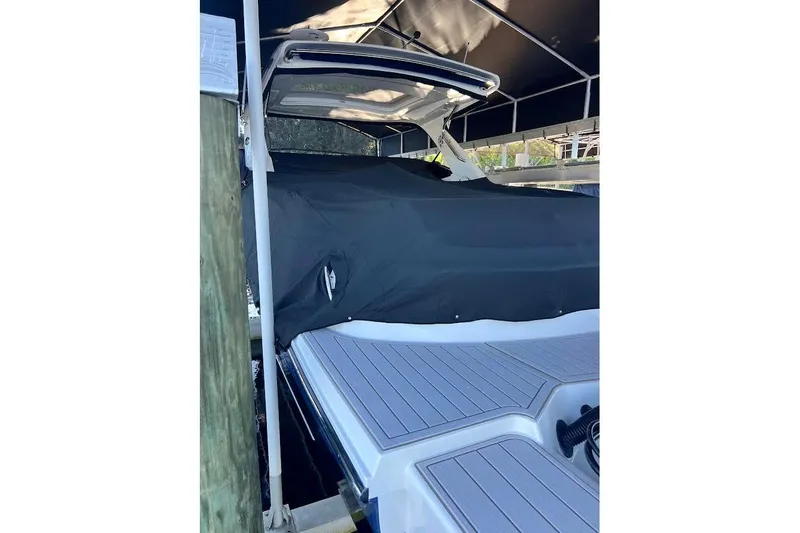 Slide: The Image of 2018 Sae Ray 38SLV OB boat covered, docked under a canopy. - 57