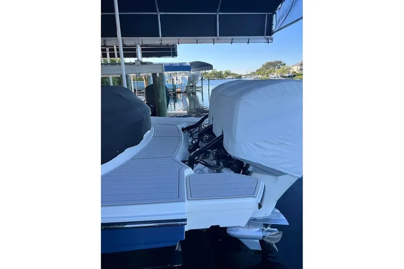 Slide: The Image of 2018 Sae Ray 38SLV OB boat docked under a canopy, rear view. - 58