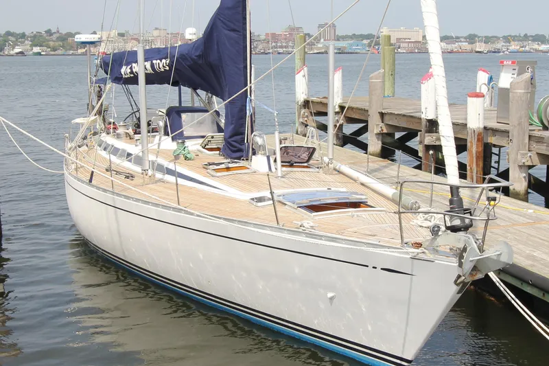 Slide: The Image of 1989 Nautor Swan 53 sailboat docked at a marina, showcasing elegant design and craftsmanship. - 1