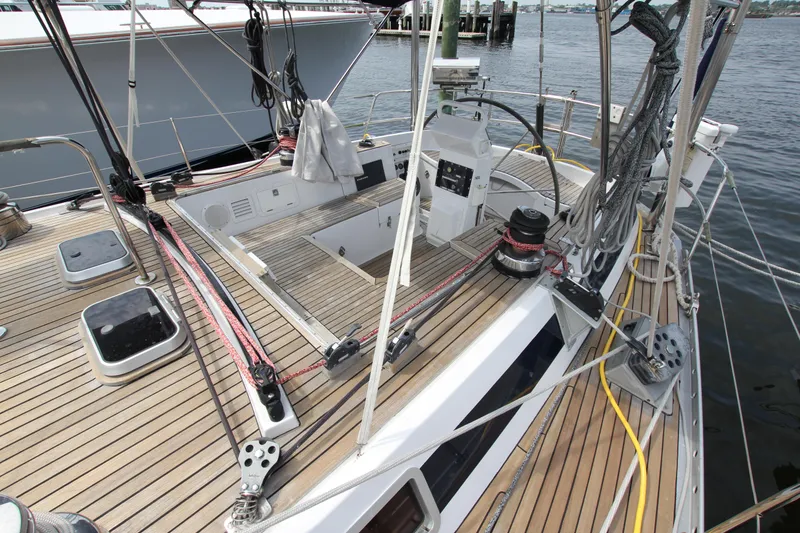 Slide: The Image of Teak deck of 1989 Nautor Swan 53 sailboat, featuring winches and rigging. - 11