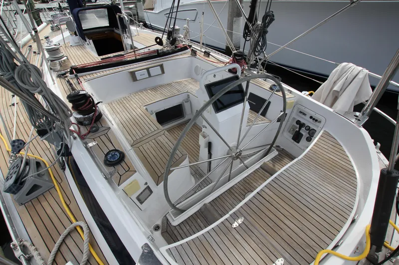 Slide: The Image of Cockpit of 1989 Nautor Swan 53 sailboat with wooden deck and steering wheel. - 12