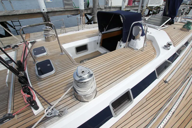 Slide: The Image of Teak deck of 1989 Nautor Swan 53 sailboat, featuring winches and hatches. - 15