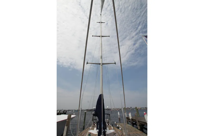 Slide: The Image of Swan 53 sailboat mast view, Nautor Swan 1989 model, docked under cloudy sky. - 17