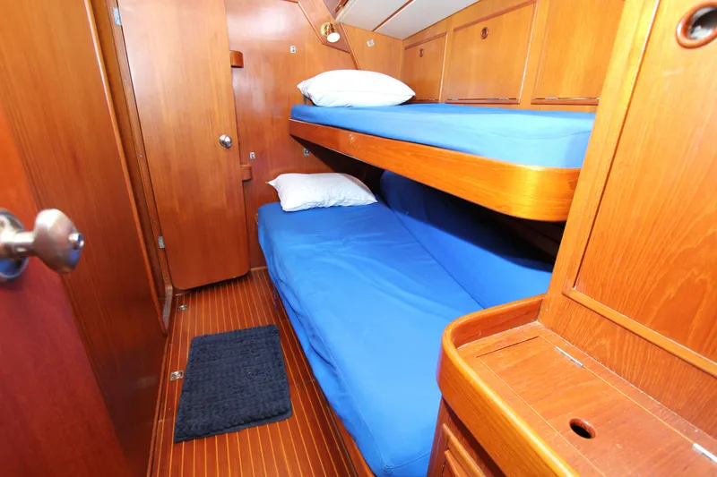 Slide: The Image of Cozy cabin with wooden interior and blue bedding on 1989 Nautor Swan 53 yacht. - 28