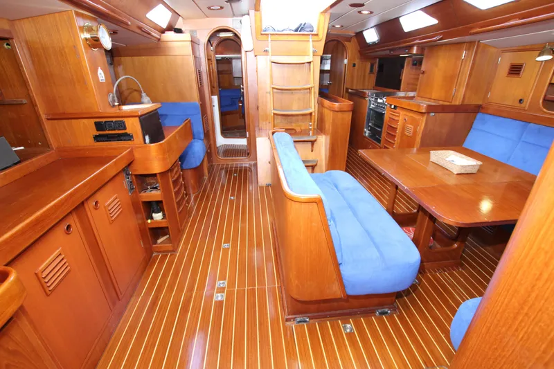 Slide: The Image of Interior of 1989 Nautor Swan 53 yacht with wooden finish and blue seating. - 30
