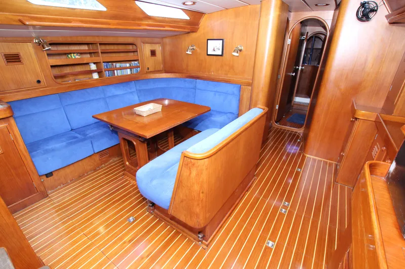 Slide: The Image of Luxurious 1989 Nautor Swan 53 yacht interior with blue seating and wooden finishes. - 31